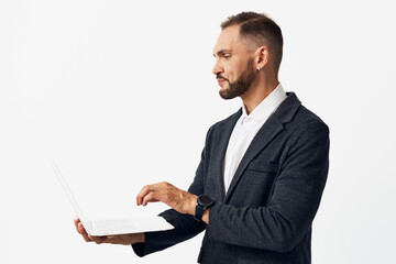 A professional man stands against a vibrant color background, focused and confident while using a...