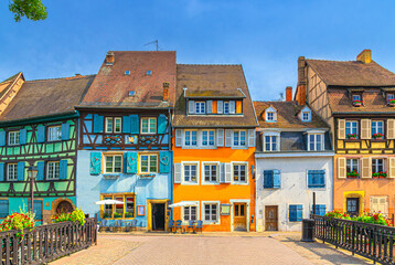 Colorful houses medieval buildings half-timbered style on Quai de la Poissonner in The Fishmonger’s district old town Colmar city historic centre in sunny summer day, Alsace Grand Est region, France