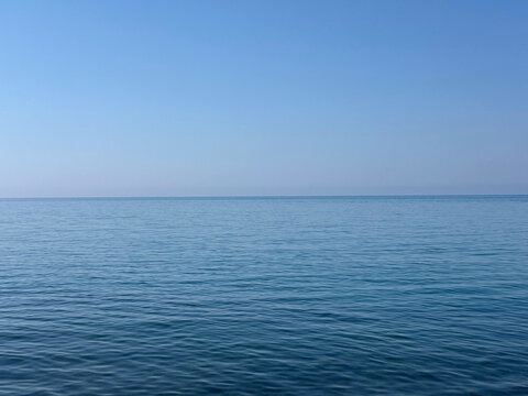 The calmiest sea water and clear blue sky.