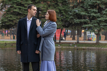 A young couple poses in an autumn park