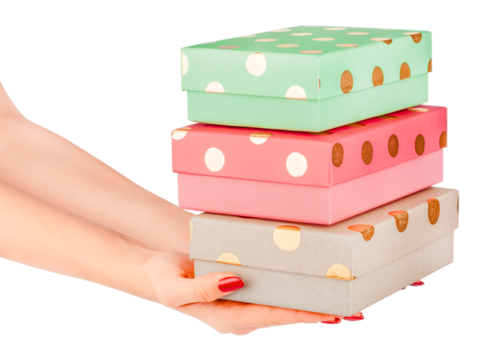 Female hands holding a stack of three colorful gift boxes with gold polka dots pastel green, pink, and beige packages isolated festive and cheerful concept birthday, Christmas celebration.