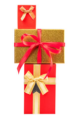 Vertical stack of elegant red and gold gift boxes decorated with satin bows and ribbons, symbolizing luxury celebration and holiday spirit, isolated