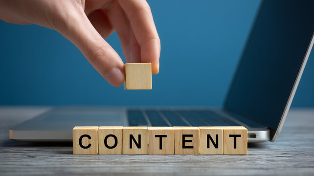 Hand placing a cube near the word content by a laptop symbolizing content creation, strategic publishing, and a disciplined editorial workflow.
