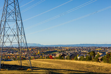 Colorado Living. Centennial, Colorado - Denver Metro Area Residential Autumn Panorama with high voltage poles and the view of the Front Range mountains in the distance