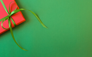 Green New Year's background with space for text and gifts. Top view.