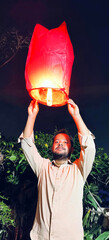 man floating sky lantern