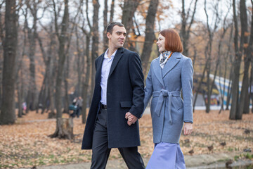 A couple in love is walking in an autumn park