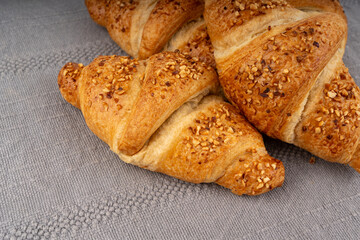 Delicious croissant with nut crumbs, sweet French bakery