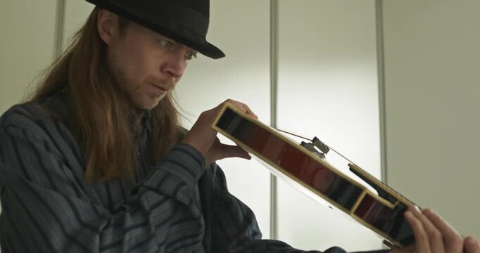 Male Musician Diligently Take Care of Instrument. Wipe Dust from Mandolin 4K 10-bit