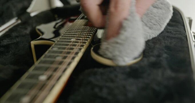 Male Musician Diligently Take Care of Instrument. Wipe Dust from Mandolin 4K 10-bit