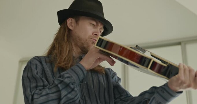 Male Musician Diligently Take Care of Instrument. Wipe Dust from Mandolin 4K 10-bit