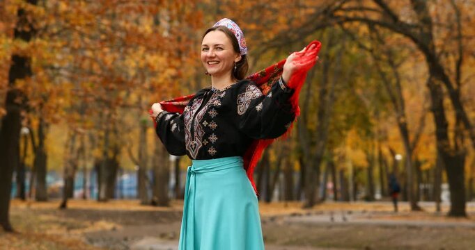 Young beautiful woman in a headscarf in an autumn park
