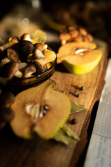 Honey mushrooms with bay leaves and quince on a rustic wooden table