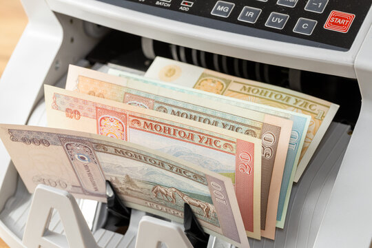 Mongolia money, Mongolian banknotes counting machine. Financial background, business concept, close up
