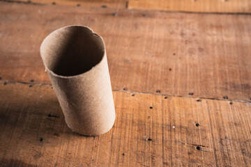 Worn toilet paper on an old wooden table