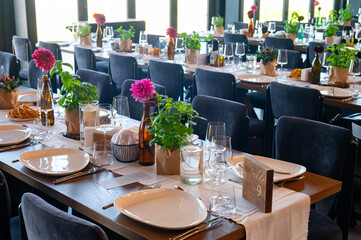 Elegant Wedding Reception Hall with Floral and Green Table Decorations