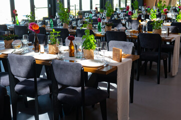 Elegant Wedding Reception Hall with Floral and Green Table Decorations