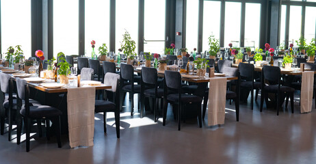 Elegant Wedding Reception Hall with Floral and Green Table Decorations