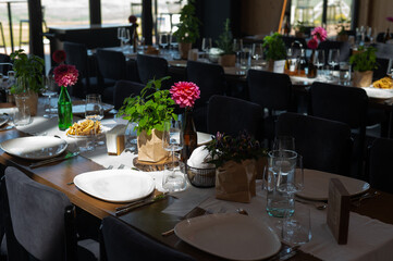 Elegant Wedding Reception Hall with Floral and Green Table Decorations