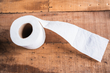 Worn toilet paper on an old wooden table