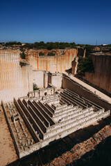 Dramatic limestone quarry labyrinth in Menorca. Abstract, textured stone walls.