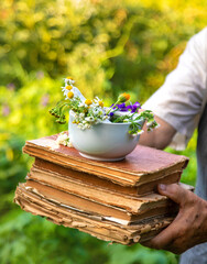 Woman with medicinal herbs in a meadow. Selective focus.