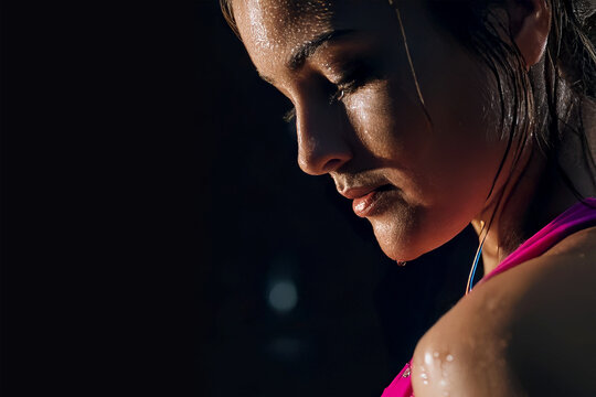 Fit Woman Resting After Intense Workout Sweating on Dark Background