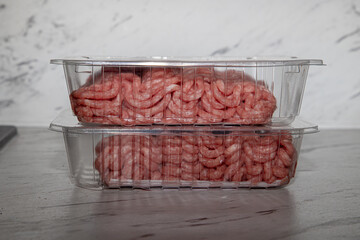 Fresh minced meat packed in plastic trays on a supermarket shelf