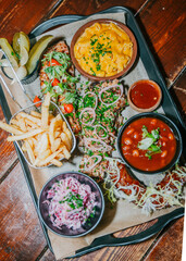 A tray of food with a variety of dishes including macaroni and cheese, beans