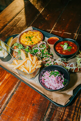A tray of food with a variety of dishes including macaroni and cheese, beans