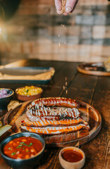 A plate of food with a person sprinkling something on it