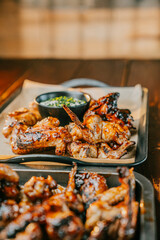 A plate of chicken wings with a dipping sauce