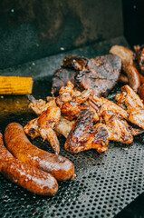 A plate of food with meat and corn on a grill