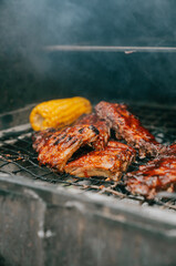 A rack of ribs and corn on a grill