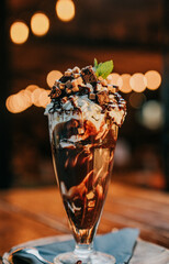 A chocolate milkshake in a glass with whipped cream
