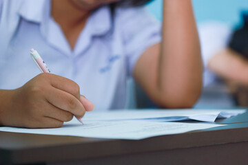 The students were doing the exams inside the classroom with stress.Assessment examination of high school students
