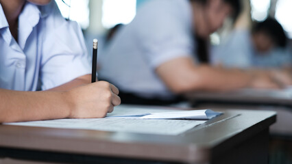 Assessment examination of high school students dressed in uniform.The students were doing the exams inside the classroom with stress