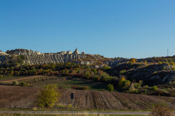 Fototapeta premium An autumn landscape with a road in northern Moldova, through wooded and mountainous terrain.