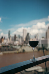 red wine on terrace with Bangkok city skyline at sunset, cocktail on rooftop, vibrant cityscape and luxury panorama view