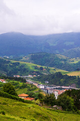 Fototapeta premium Town of Deba Along the Deba River on a Cloudy Day
