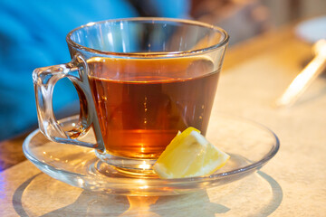 Hot turkish tea drinks with lemon in a mug or transparent glass on a white background