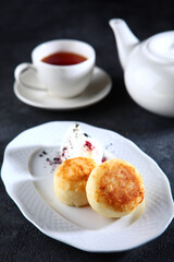 Cottage cheese pancakes with cream sauce.Breakfast with cheese pancakes. Cheesecakes.