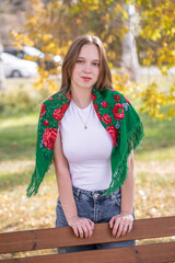 Portrait of a young beautiful girl in an autumn park