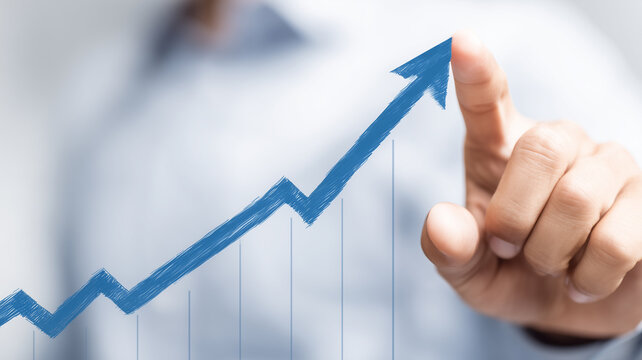 Hand guiding an ascending growth arrow on a chart, representing positive performance momentum strategy and long term business success.
