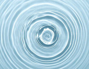 Top-down view of concentric water ripples spreading outwards from a central point, creating a calming and serene pattern.