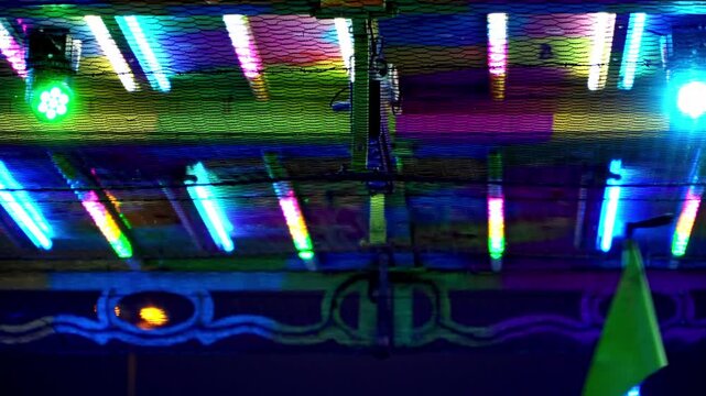 Bumper car banners moving along the electrical mesh of a christmas fairground attraction with copy space