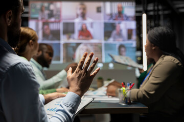 Staff from a multinational company coordinate with global partners via web call for a night strategy session, reviewing proposals and sharing insights in real time collaboration. Project agenda.