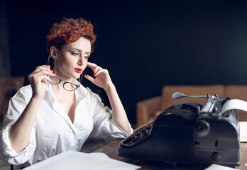 red-haired Woman Writer in a Dramatic Setting with Vintage Typewriter and Crumpled Papers