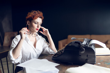 red-haired Woman Writer in a Dramatic Setting with Vintage Typewriter and Crumpled Papers