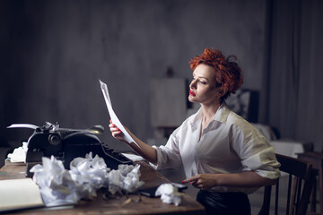red-haired Woman Writer in a Dramatic Setting with Vintage Typewriter and Crumpled Papers